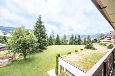 a view of a yard from the balcony of a house at Apartment with balcony 10 min walk from the slopes in Megève