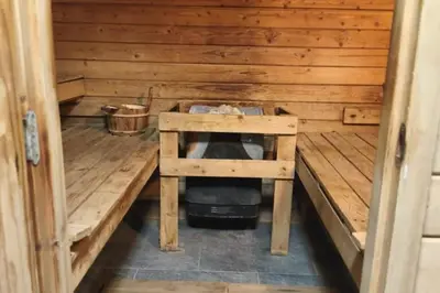 a inside of a wooden cabin with a stove in it at Apartment with balcony 10 min walk from the slopes in Megève