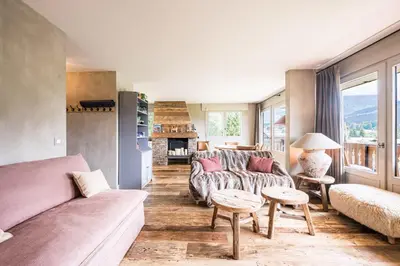 a living room with a couch and a table at Apartment with balcony 10 min walk from the slopes in Megève