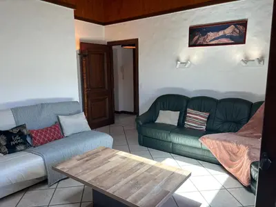 a living room with two couches and a coffee table at Le Mont - Vue montagne - Parking - Wifi - Nature in Demi-Quartier