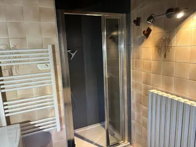 a shower with a glass door in a bathroom at Le Mont - Vue montagne - Parking - Wifi - Nature in Demi-Quartier