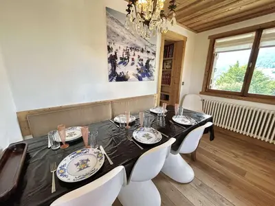 a dining room with a table with chairs and a chandelier at Appartement 4 pièces, 6 couchages, balcon, parking, Megève - FR-1-597-194 in Megève