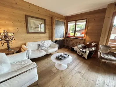 a living room with white furniture and wooden walls at Appartement 4 pièces, 6 couchages, balcon, parking, Megève - FR-1-597-194 in Megève