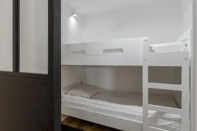 a bunk bed with a ladder in a room at Studio Kayla - Espace bien-etre Piscine Face au Kandahar in Les Houches