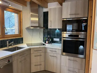 a kitchen with a sink and a stove top oven at Chalet Alpéa - Jacuzzi vue montagne - Neuf in Saint-Gervais-les-Bains