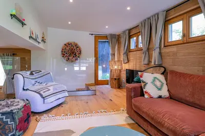 a living room with a couch and a chair at Cocoon - Jardin privé au cœur de Megève in Megève
