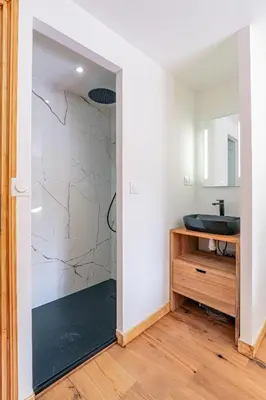 a bathroom with a sink and a mirror at Cocoon - Jardin privé au cœur de Megève in Megève