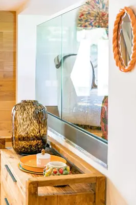 a table with a plate of food and a mirror at Cocoon - Jardin privé au cœur de Megève in Megève