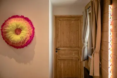 a room with a door and a wreath on the wall at Cocoon - Jardin privé au cœur de Megève in Megève