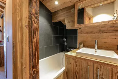 a bathroom with a sink and a bath tub at Le Duplex in Megève