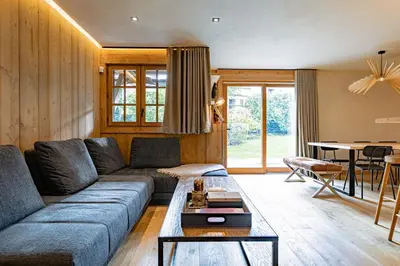 a living room with a couch and a table at Escapade in Megève