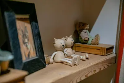 two stuffed cats sitting on a shelf next to a mirror at Escapade in Megève