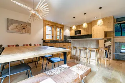 a kitchen with a large wooden table and chairs at Escapade in Megève