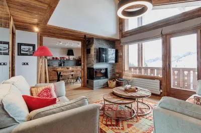 a living room with a couch and a table at Les Mesanges in Megève