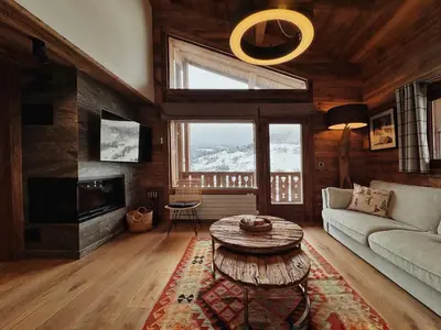 a living room with a couch and a table at Les Mesanges in Megève