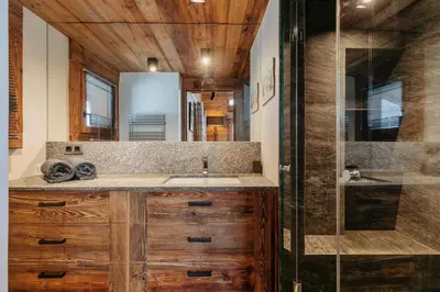 a bathroom with a sink and a shower at Les Mesanges in Megève