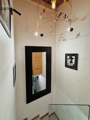 a mirror in a black frame on a wall in a room at Les Mesanges in Megève