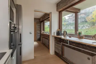 a bathroom with a sink and a window at Red Touch - Balcon vue et confort en famille in Megève