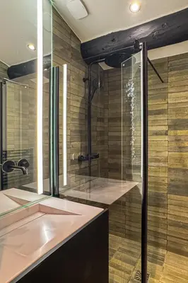a bathroom with a shower and a sink at Le Black Wood in Demi-Quartier