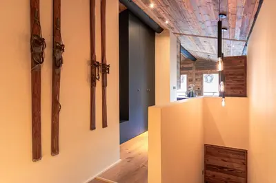 a hallway with wooden axes on the walls at Le Black Wood in Demi-Quartier