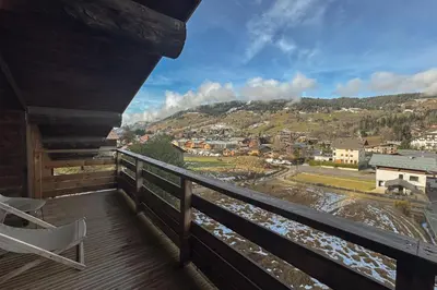 a balcony with a view of a town at Le Black Wood in Demi-Quartier