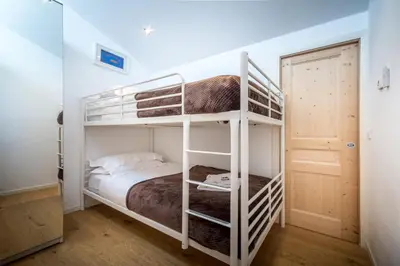 a bedroom with two bunk beds in a room at Rupicapra apartment - Chamonix All Year in Chamonix-Mont-Blanc