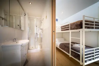 a small bathroom with a sink and a bunk bed at Rupicapra apartment - Chamonix All Year in Chamonix-Mont-Blanc