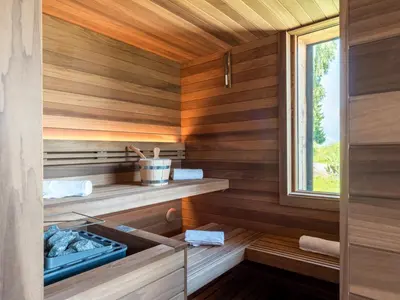 a sauna with wooden walls and a window at Chalet Victory I Le Chalet Club in Combloux
