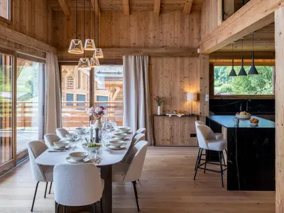 a dining room with a table and chairs at Chalet Victory I Le Chalet Club in Combloux