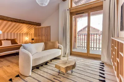 a living room with a couch and a bed at AO HOUSE - Chalet PAN BENA in Les Houches