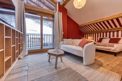 a living room with a couch and a large window at AO HOUSE - Chalet PAN BENA in Les Houches