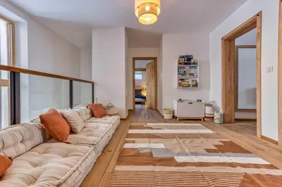 a living room with a couch and a rug at AO HOUSE - Chalet PAN BENA in Les Houches
