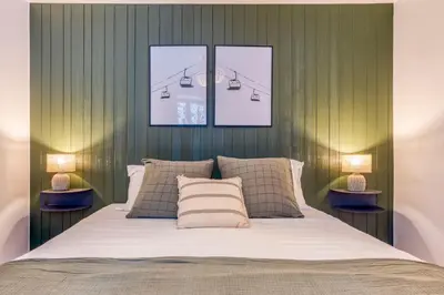 a bedroom with a bed with three pictures on the wall at AO HOUSE - Chalet PAN BENA in Les Houches