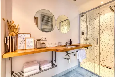 a bathroom with a shower and a sink and mirror at AO HOUSE - Chalet PAN BENA in Les Houches