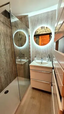 a bathroom with a sink and a shower and a mirror at Ski in Ski out MNT Direct piste access in Les Houches