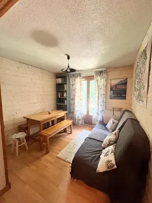 a bedroom with a bed and a wooden table at Entre amis-Résidence La Piste Bleue-Ski aux pieds in Saint-Gervais-les-Bains