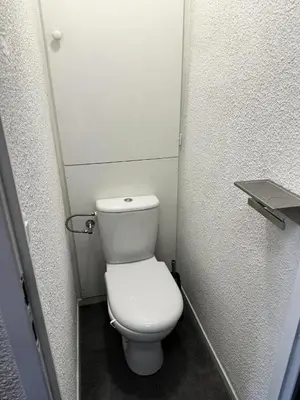 a bathroom with a white toilet in a stall at Chalets Autrichiens - T2/4PAX - CHALETS AUTRICHIENS MAE-3263 in Megève