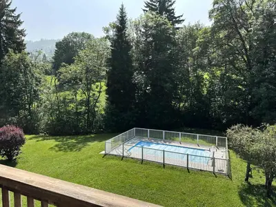 a swimming pool in the middle of a yard at Chalets Autrichiens - T2/4PAX - CHALETS AUTRICHIENS MAE-3263 in Megève