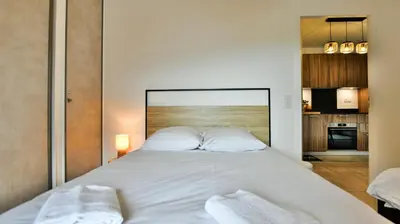 a bedroom with a large white bed with two pillows at Le Sève - B103 in Samoëns