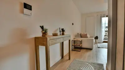 a living room with a table and a couch at Le Sève - B103 in Samoëns