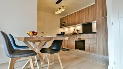 a kitchen with a wooden table and two chairs at Le Sève - B103 in Samoëns