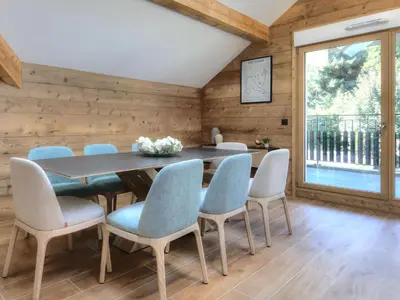 a dining room with a table and blue chairs at 3 pièces avec balcon, proche centre et télécabine, animaux admis - FR-1-663-50 in Saint-Gervais-les-Bains