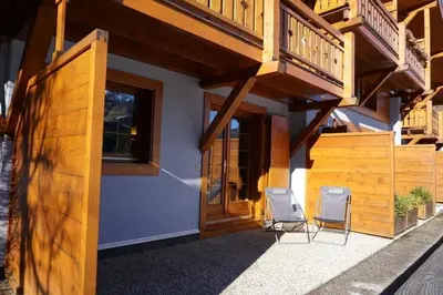 a house with two chairs and a balcony at Contamines-Monjoie in Les Contamines-Montjoie