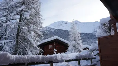 a cabin in the mountains covered in snow at Contamines-Monjoie in Les Contamines-Montjoie