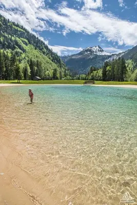 a person standing in the water on a beach at Contamines-Monjoie in Les Contamines-Montjoie