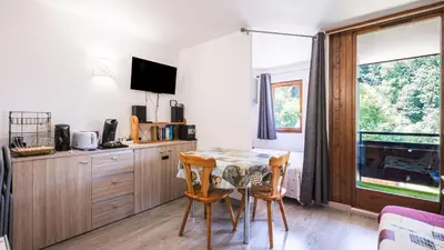 a kitchen with a table and chairs and a window at Grand Horizon 1 N204 - 2P4 in Morillon