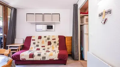 a small bedroom with a bed and a table at Grand Horizon 1 N204 - 2P4 in Morillon