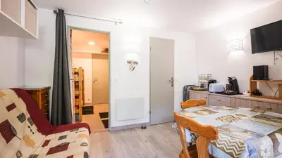 a living room with a table and chairs and a room at Grand Horizon 1 N204 - 2P4 in Morillon