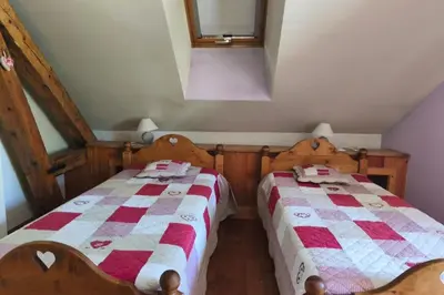 two beds sitting next to each other in a room at Accommodation of 167 m2 with views of Mont Blanc in Combloux