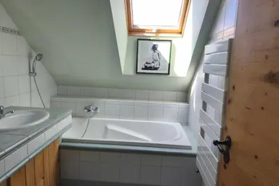 a bathroom with a tub and a sink and a window at Accommodation of 167 m2 with views of Mont Blanc in Combloux